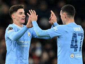 Manchester City's Argentinian striker #19 Julian Alvarez (L) celebrates scoring the team's third goal with Manchester City's English midfielder #47 Phil Foden during the UEFA Champions League Group G football match between Manchester City and RG Leipzig at the Etihad Stadium, in Manchester, north west England, on November 28, 2023. (Photo by Oli SCARFF / AFP)