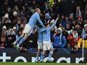 Manchester City's Argentinian striker #19 Julian Alvarez (R) celebrates scoring the team's third goal during the UEFA Champions League Group G football match between Manchester City and RG Leipzig at the Etihad Stadium, in Manchester, north west England, on November 28, 2023. (Photo by Paul ELLIS / AFP)
