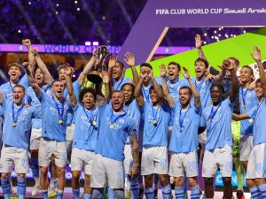 Manchester City players celebrate with their winning trophy at the end of the FIFA Club World Cup 2023 football final match against Brazil's Fluminense at King Abdullah Sports City Stadium in Jeddah on December 22, 2023. (Photo by Giuseppe CACACE / AFP)