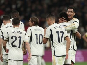 Real Madrid's Brazilian forward #11 Rodrygo is congratulated by Real Madrid's English midfielder #5 Jude Bellingham for scoring his team's second goal during the Spanish league football match between Real Madrid CF and Villarreal CF at the Santiago Bernabeu stadium in Madrid on December 17, 2023. (Photo by Thomas COEX / AFP)