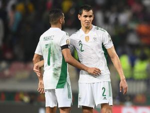 Algeria's forward Riyad Mahrez (L) and Algeria's defender Aissa Mandi (R) react after Ivory Coast won the Group E Africa Cup of Nations (CAN) 2021 football match between Ivory Coast and Algeria at Stade de Japoma in Douala on January 20, 2022. (Photo by CHARLY TRIBALLEAU / AFP)