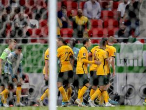 Australia's players celebrate after a goal during the FIFA World Cup 2022 play-off qualifier football match between UAE and Australia at Ahmad bin Ali stadium in Qatar's Ar-Rayyan city on June 7, 2022. (Photo by Mustafa ABUMUNES / AFP)
