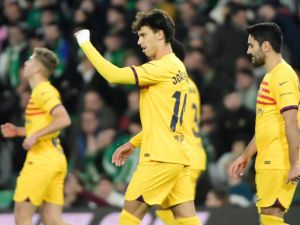 Barcelona's Portuguese forward #14 Joao Felix (C) celebrates scoring his team's third goal during the Spanish League football match between Real Betis and FC Barcelona at the Benito Villamarin stadium in Seville on January 21, 2024. (Photo by CRISTINA QUICLER / AFP)