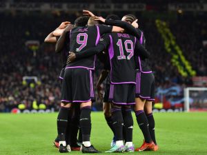 Bayern Munich's players celebrate the opening goal scored by Bayern Munich's French forward #11 Kingsley Coman during the UEFA Champions League group A football match between Manchester United and FC Bayern Munich at Old Trafford stadium in Manchester, north west England, on December 12, 2023. (Photo by PETER POWELL / AFP)