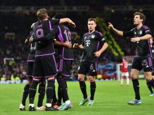 Bayern Munich's players celebrate the opening goal scored by Bayern Munich's French forward #11 Kingsley Coman during the UEFA Champions League group A football match between Manchester United and FC Bayern Munich at Old Trafford stadium in Manchester, north west England, on December 12, 2023. (Photo by PETER POWELL / AFP)