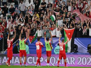 Jordan's players salute the attendance after the end of the Qatar 2023 AFC Asian Cup Group E football match between Malaysia and Jordan at the Al-Janoub Stadium in Al-Wakrah, south of Doha on January 15, 2024. (Photo by HECTOR RETAMAL / AFP)