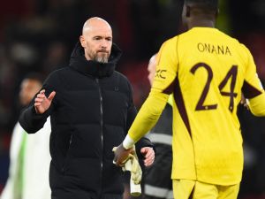 Manchester United's Dutch manager Erik ten Hag shakes hands with Manchester United's Cameroonian goalkeeper #24 Andre Onana after the UEFA Champions League group A football match between Manchester United and FC Bayern Munich at Old Trafford stadium in Manchester, north west England, on December 12, 2023. (Photo by PETER POWELL / AFP)
