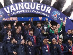 Paris Saint-Germain' players celebrate with the trophy after winning the French Champions' Trophy (Trophee des Champions) football match between Paris Saint-Germain (PSG) and Toulouse FC at the Parc des Princes stadium in Paris on January 3, 2024. (Photo by FRANCK FIFE / AFP)