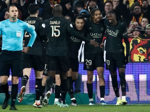 Paris Saint-Germain's French forward #29 Bradley Barcola (2nd R) celebrates with teammates after scoring his team's first goal during the French L1 football match between RC Lens and Paris Saint-Germain (PSG) at Stade Bollaert-Delelis in Lens, northern France on January 14, 2024. (Photo by Sameer Al-Doumy / AFP)