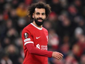 Liverpool's Egyptian striker #11 Mohamed Salah smiles during the UEFA Europa League group E football match between Liverpool and Linzer ASK at Anfield in Liverpool, north west England on November 30, 2023. (Photo by Oli SCARFF / AFP)