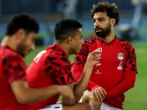 Egypt's forward Mohamed Salah (R) warms up before the start of the friendly football match between Belgium and Egypt at the Jaber Al-AhmadQ Stadium in Kuwait City on November 18, 2022. (Photo by YASSER AL-ZAYYAT / AFP)