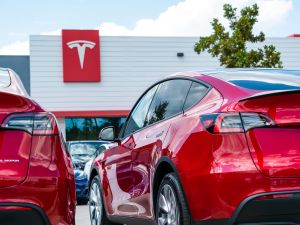 Two red model Y in front of Tesla Motors