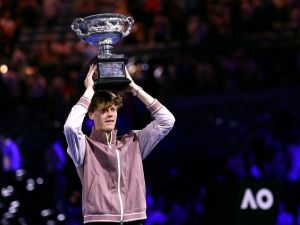 Italy's Jannik Sinner celebrates with the Norman Brookes Challenge Cup trophy after defeating Russia's Daniil Medvedev in the men's singles final match on day 15 of the Australian Open tennis tournament in Melbourne on January 28, 2024. (Photo by David GRAY / AFP) 