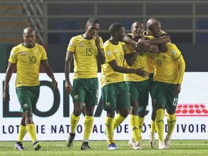 South Africa's defender #12 Thapelo Maseko celebrates with teammates after scoring his team's fourth goal during the Africa Cup of Nations (CAN) 2024 group E football match between South Africa and Namibia at Amadou Gon Coulibaly Stadium in Korhogo on January 21, 2024. (Photo by Fadel Senna / AFP)