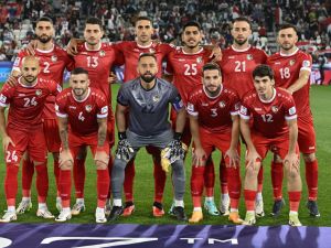 Syria's starting eleven pose for the group photo before the start of the Qatar 2023 AFC Asian Cup Group B football match between Uzbekistan and Syria at the Jassim bin Hamad Stadium in Doha on January 13, 2024. (Photo by HECTOR RETAMAL / AFP)