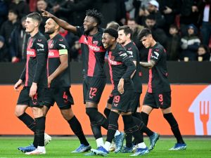 Bayer Leverkusen's Burkinabe defender #12 Edmond Tapsoba (3rd L) celebrates with Bayer Leverkusen's English midfielder #19 Nathan Tella (4th L) and other teammates after scoring the 2-0 goal during the UEFA Europa League Group H football match between Bayer 04 Leverkusen and Molde FK in Leverkusen, on December 14, 2023. (Photo by ULRICH HUFNAGEL / AFP)