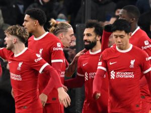 Liverpool's Egyptian striker #11 Mohamed Salah (C) celebrates with teammates after scoring their third goal during the UEFA Europa League group E football match between Liverpool and Linzer ASK at Anfield in Liverpool, north west England on November 30, 2023. (Photo by Oli SCARFF / AFP)