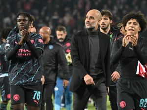 Manchester City's Spanish manager Pep Guardiola (C) and Manchester City players celebrate after winning the UEFA Champions League Group G day 6 group stage football match between Crvena Zvezda (Red Star Belgrade) and Manchester City at the Red Star stadium in Belgrade, on December 13, 2023. (Photo by ANDREJ ISAKOVIC / AFP)