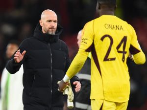 Manchester United's Dutch manager Erik ten Hag shakes hands with Manchester United's Cameroonian goalkeeper #24 Andre Onana after the UEFA Champions League group A football match between Manchester United and FC Bayern Munich at Old Trafford stadium in Manchester, north west England, on December 12, 2023. (Photo by PETER POWELL / AFP)