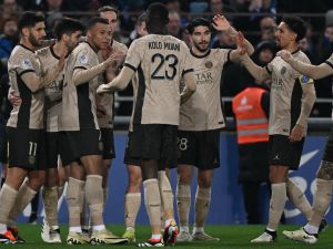 Paris Saint-Germain's Spanish forward #11 Marco Asensio (L) is congratulated by teammates after scoring a goal during the French L1 football match between RC Strasbourg (RCS) and Paris Saint-Germain (PSG) at the Meinau stadium in Strasbourg, on February 2, 2024. (Photo by PATRICK HERTZOG / AFP)