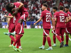 Qatar's forward #11 Akram Afif (L) celebrates with teammates after scoring his team's first goal during the Qatar 2023 AFC Asian Cup Group A football match between Tajikistan and Qatar at the Al-Bayt Stadium in Al Khor, north of Doha on January 17, 2024. (Photo by HECTOR RETAMAL / AFP)