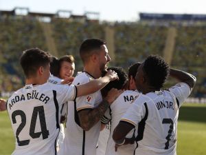Real Madrid's French defender #18 Aurelien Tchouameni celebrates with teammates after scoring his team's second goal during the Spanish league football match between UD Las Palmas and Real Madrid CF at the Gran Canaria stadium in Las Palmas de Gran Canaria on January 27, 2024. (Photo by DESIREE MARTIN / AFP)