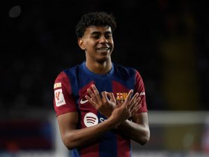 Barcelona's Spanish forward #27 Lamine Yamal celbrates scoring the opening goal during the Spanish league football match between FC Barcelona and Granada FC at the Estadi Olimpic Lluis Companys in Barcelona on February 11, 2024. (Photo by Josep LAGO / AFP)