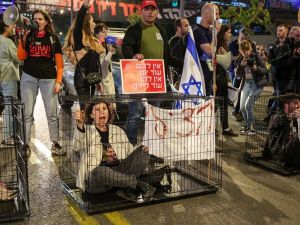 مستوطنين داخل أقفاص في تل أبيب