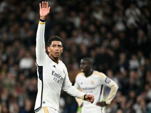 Real Madrid's English midfielder #5 Jude Bellingham waves during the UEFA Champions League last 16 second leg football match between Real Madrid CF and RB Leipzig at the Santiago Bernabeu stadium in Madrid on March 6, 2024. (Photo by JAVIER SORIANO / AFP)