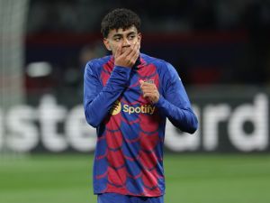 Barcelona's Spanish forward #27 Lamine Yamal warms up prior to the UEFA Champions League last 16 second leg football match between FC Barcelona and SSC Napoli at the Estadi Olimpic Lluis Companys in Barcelona on March 12, 2024. (Photo by LLUIS GENE / AFP)