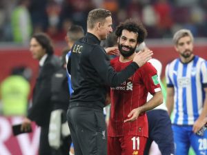 Liverpool's Dutch assistant manager Pepijn Lijnders (L) speaks with Liverpool's Egyptian midfielder Mohamed Salah following the 2019 FIFA Club World Cup semi-final football match between Mexico's Monterrey and England's Liverpool at the Khalifa International Stadium in the Qatari capital Doha on December 18, 2019. Liverpool will face Flamengo in the Final of the FIFA Club World Cup on December 21. / AFP / KARIM JAAFAR