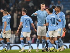 Manchester City's players celebrate on the pitch after the UEFA Champions League round of 16, second-leg, football match between Manchester City and FC Copenhagen at the Etihad Stadium, in Manchester, north west England, on March 6, 2024. City won the game 3-1, 6-2 on aggregate. (Photo by Paul ELLIS / AFP)