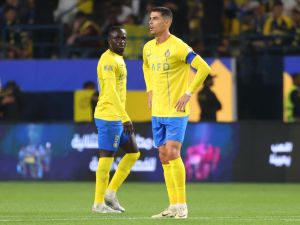 Nassr's Senegalese Forward #10 Sadio Mane and Nassr's Portuguese forward #07 Cristiano Ronaldo react during the Saudi Pro League football match between Al-Nassr and Al-Raed in Riyadh's Al-Awal Park Stadium on March 7, 2024. (Photo by Fayez NURELDINE / AFP)