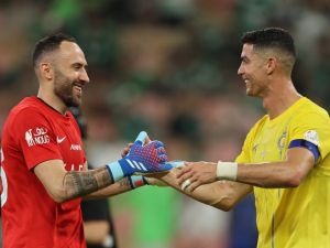 Nassr's Portuguese forward #07 Cristiano Ronaldo celebrates with Nassr's Colombian goalkeeper #26 David Ospina after the Saudi Pro League football match between Al-Ahli and Al-Nassr at the King Abdullah Sport City Stadium in Jeddah on March 15, 2024. (Photo by AFP)