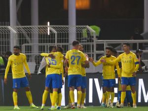 Nassr's players celebrate their team's third goal during the Saudi Pro League football match between Al-Shabab and Al-Nassr at the Al-Shabab Club Stadium in Riyadh on February 25, 2024. (Photo by Fayez NURELDINE / AFP)