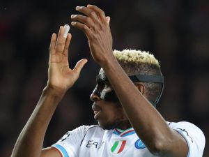 Napoli's Nigerian forward #09 Victor Osimhen claps during the UEFA Champions League last 16 second leg football match between FC Barcelona and SSC Napoli at the Estadi Olimpic Lluis Companys in Barcelona on March 12, 2024. (Photo by LLUIS GENE / AFP)