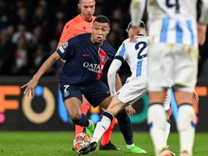 Paris Saint-Germain's French forward #07 Kylian Mbappe (CL) fights for the ball with Real Sociedad's Spanish midfielder #22 Benat Turrientes (CR) during the UEFA Champions League round of 16 first leg football match between Paris Saint-Germain (PSG) and Real Sociedad at the Parc des Princes Stadium in Paris, on February 14, 2024. (Photo by MIGUEL MEDINA / AFP)
