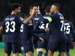 Paris Saint-Germain's French forward #07 Kylian Mbappe celebrates scoring his team's second goal, with teammates, during the UEFA Champions League last 16 second leg football match between Real Sociedad and Paris Saint-Germain (PSG) at the Anoeta stadium in San Sebastian on March 5, 2024. (Photo by FRANCK FIFE / AFP)