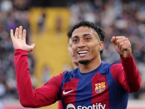 Barcelona's Brazilian forward #11 Raphinha celebrates scoring his team's first goal during the Spanish league football match between FC Barcelona and Getafe CF at the Estadi Olimpic Lluis Companys in Barcelona on February 24, 2024. (Photo by LLUIS GENE / AFP)