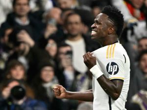 Real Madrid's Brazilian forward #07 Vinicius Junior celebrates scoring the opening goal during the UEFA Champions League last 16 second leg football match between Real Madrid CF and RB Leipzig at the Santiago Bernabeu stadium in Madrid on March 6, 2024. (Photo by JAVIER SORIANO / AFP)