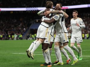 Real Madrid players react to Celta's owngoal during the Spanish league football match between Real Madrid CF and RC Celta de Vigo at the Santiago Bernabeu stadium in Madrid on March 10, 2024. (Photo by Pierre-Philippe MARCOU / AFP)