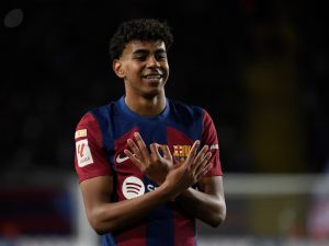 Barcelona's Spanish forward #27 Lamine Yamal celbrates scoring the opening goal during the Spanish league football match between FC Barcelona and Granada FC at the Estadi Olimpic Lluis Companys in Barcelona on February 11, 2024. (Photo by Josep LAGO / AFP)