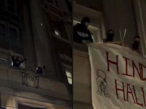 Columbia University students on the balcony of Hamilton Hall and spreading a billboard reading "Hind's Hall" along with Hadala characters. 