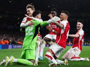 From L) Arsenal's Spanish goalkeeper #22 David Raya, Arsenal's Norwegian midfielder #08 Martin Odegaard, Arsenal's English midfielder #07 Bukayo Saka, Arsenal's English defender #04 Ben White and Arsenal's English midfielder #41 Declan Rice celebrate after winning the penalty shoot-out session of the UEFA Champions League last 16 second leg football match between Arsenal and Porto FC at the Arsenal Stadium in north London, on March 12, 2024. (Photo by Adrian DENNIS / AFP)
