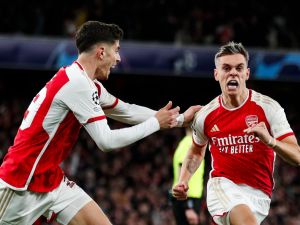 Arsenal's Belgian midfielder #19 Leandro Trossard (R) celebrates after scoring his team second goal during the UEFA Champions League quarter final first-leg football match between Arsenal and Bayern Munich at the Arsenal Stadium, in north London, on April 9, 2024. (Photo by Ian Kington / IKIMAGES / AFP)