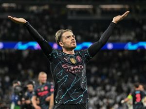 Manchester City's English midfielder #10 Jack Grealish celebrates at the end of the UEFA Champions League quarter final first leg football match between Real Madrid CF and Manchester City at the Santiago Bernabeu stadium in Madrid on April 9, 2024. (Photo by JAVIER SORIANO / AFP)