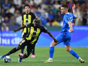 Ittihad's French midfielder #07 N'Golo Kante runs past Hilal's Serbian midfielder #22 Sergej Milinkovic-Savic during the Saudi Super Cup final football match between Al-Ittihad and Al-Hilal at the Mohammed bin Zayed Stadium in Abu Dhabi on April 11, 2024. (Photo by Ryan LIM / AFP)
