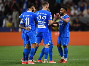 Hilal's Saudi midfielder #29 Salem al-Dawsari celebrates with teammates after scoring his team's second goal during the Saudi Super Cup final football match between Al-Ittihad and Al-Hilal at the Mohammed bin Zayed Stadium in Abu Dhabi on April 11, 2024. (Photo by Ryan LIM / AFP)