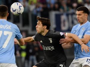 Juventus' Italian forward #07 Federico Chiesa fights for the ball with Lazio's Montenegrin defender #77 Adam Marusic and Lazio's Italian defender #15 Nicolo Casale during the Italian Serie A football match between Lazio and Juventus at the Olympic stadium in Rome, on March 30, 2024. (Photo by Filippo MONTEFORTE / AFP)