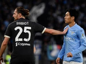 Juventus' French midfielder #25 Adrien Rabiot pushes Lazio's Japanese midfielder #06 Daichi Kamada during the Italian Serie A football match between Lazio and Juventus at the Olympic stadium in Rome, on March 30, 2024. (Photo by Filippo MONTEFORTE / AFP)